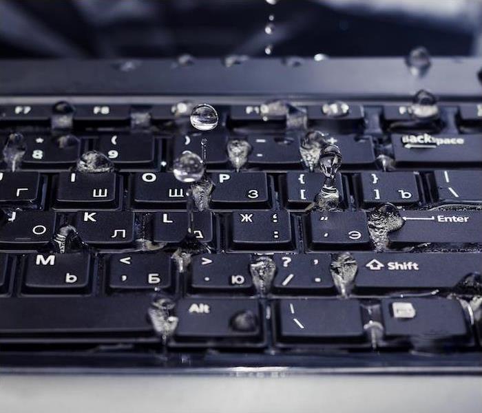 a black keyboard showing signs of water damage